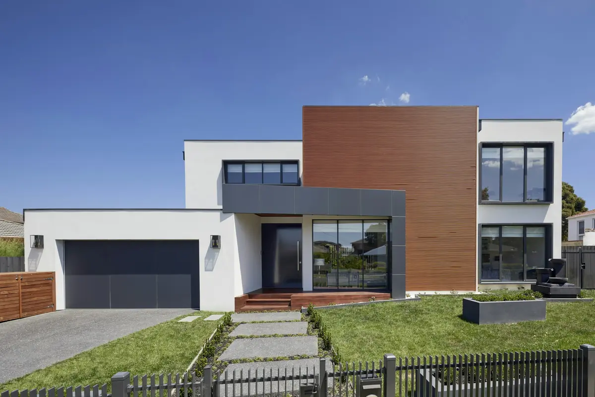 Charcoal flush-panel garage door on a modern home